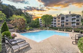 Marietta apartment for rent - an outdoor swimming pool with a sunset over an apartment building