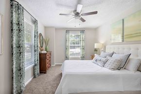 Kennesaw apartment for rent - a bedroom with a large bed and a ceiling fan