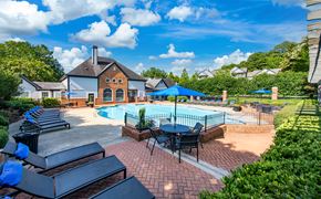 Kennesaw apartment for rent - a swimming pool with patio furniture and umbrellas