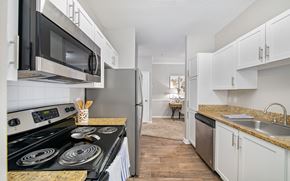 Kennesaw apartment for rent - a spacious kitchen with stainless steel appliances and white cabinets