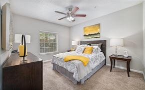 Kennesaw apartment for rent - a bedroom with a bed and a ceiling fan