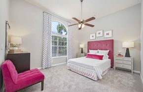 Atlanta apartment for rent - a bedroom with a bed and a chair and a ceiling fan