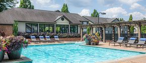 Atlanta apartment for rent - a swimming pool with lounge chairs and a house with a pool