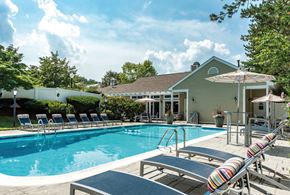 Lexington apartment for rent - a swimming pool with lounge chairs and a house in the background