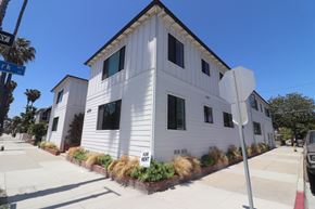 Long Beach apartment for rent - a white house with a street sign in front of it