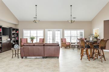 Sunset Beach apartment for rent - A living room with a brown couch and a dining table.