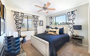 Gilbert apartment for rent - a bedroom with a large bed and a ceiling fan