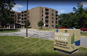 Clare townhouse for rent - A sign for Gateway Village is in front of a building.
