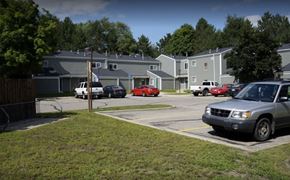 Clare townhouse for rent - A grey car is parked in a parking lot.