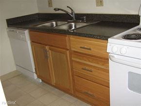 Alma townhouse for rent - A kitchen with a white dishwasher and white stove.