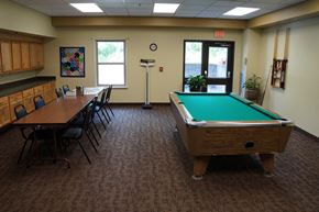 Alma townhouse for rent - A room with a pool table and chairs.