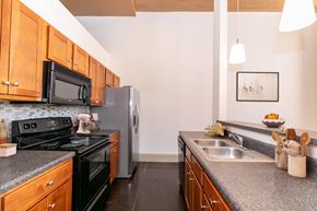 Porterdale apartment for rent - full kitchen with granite counter tops and stainless steel appliances and black appliances