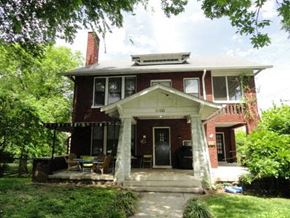 Nashville apartment for rent - a red brick house with columns and a porch