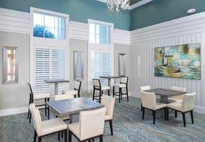 Jacksonville apartment for rent - a dining room with tables and chairs and a painting on the wall