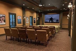 Jacksonville apartment for rent - a conference room with rows of chairs and a projector screen