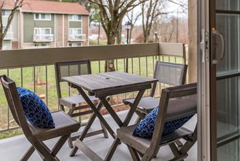 Balcony with folding table and chairs