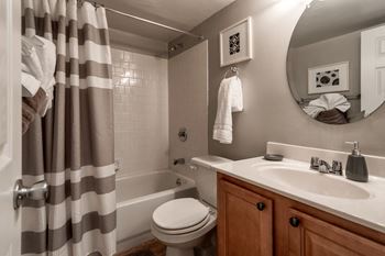 Bathroom with white subway tile and striped shower curtain