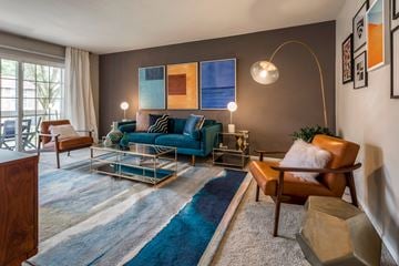 Columbia apartment for rent - a living room with a blue couch and a glass coffee table