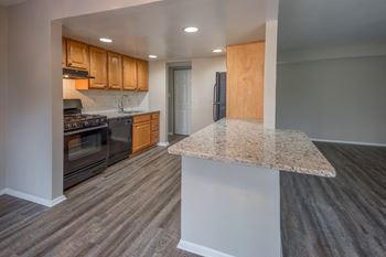 Open concept kitchen with granite island countertop