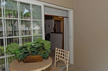 Private patio with plants and sliding glass door