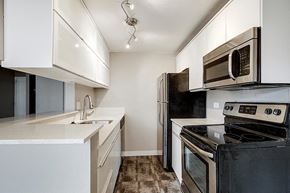 Denver apartment for rent - a kitchen with stainless steel appliances and white cabinets