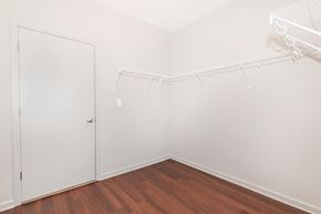 Nashville apartment for rent - a bedroom with white walls and wood flooring and a closet