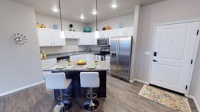 Moorhead apartment for rent - a kitchen with stainless steel appliances and a marble counter top