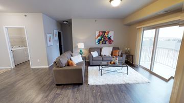 Moorhead apartment for rent - a living room with a couch and a chair and a table