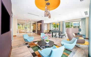 Atlanta apartment for rent - a living room with blue chairs and a table