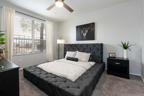 Phoenix apartment for rent - a bedroom with a bed and a ceiling fan