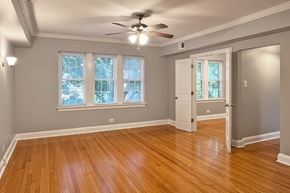 Oak Park apartment for rent - A room with a ceiling fan and wooden flooring.