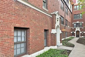 Oak Park apartment for rent - A red brick building with a white column in front.