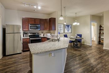 Glenbrook apartments energy efficient stainless steel appliances including a glass-topped stove and a refrigerator with ice maker