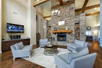 Hendersonville apartment for rent - a living room with a large stone fireplace and couches