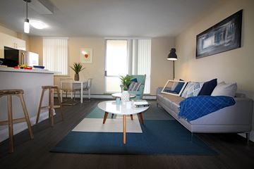 Hamilton apartment for rent - A living room with a white couch and a coffee table.