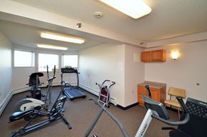 Maple Grove apartment for rent - a gym with exercise machines and a window