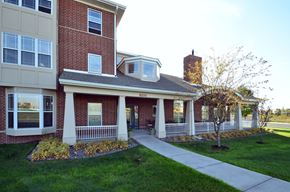 Maple Grove apartment for rent - a sidewalk in front of a brick house with a porch