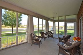 Maple Grove apartment for rent - a covered porch with wicker furniture and large windows