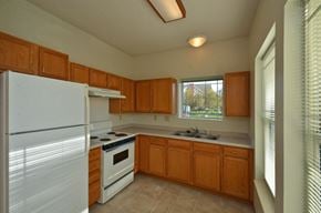 Maple Grove apartment for rent - a kitchen with white appliances and wooden cabinets