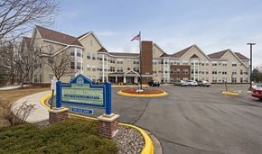 Plymouth apartment for rent - the exterior of an apartment building with a sign