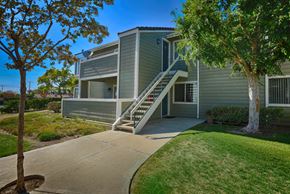 Moorpark apartment for rent - a gray house with stairs and a sidewalk in front of it