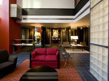 New York apartment for rent - a living room with a red couch and a table