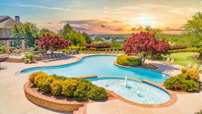 Gainesville apartment for rent - a swimming pool with a fountain at sunset