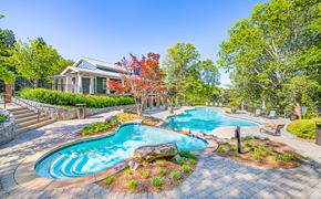 Gainesville apartment for rent - a pool and spa with a house in the background