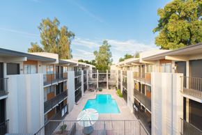 Phoenix apartment for rent - a view of a pool in the middle of apartment buildings