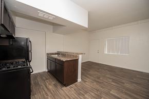 Phoenix apartment for rent - an empty kitchen and living room with a stove and refrigerator