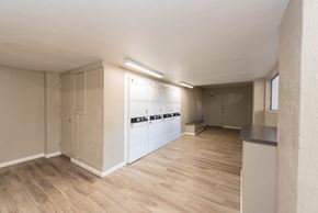 Phoenix apartment for rent - the living room and kitchen of an apartment with white appliances and wood floors
