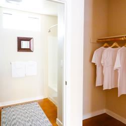 Emeryville apartment for rent - A hallway with a bench and clothes hanging on a rack.