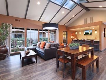 Bermuda Dunes apartment for rent - A modern living room with a black couch and a wooden table.