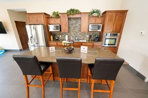 West Des Moines townhouse for rent - a kitchen with a counter top with three chairs